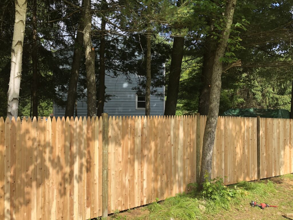 Wooden stockade fence in a back yard
